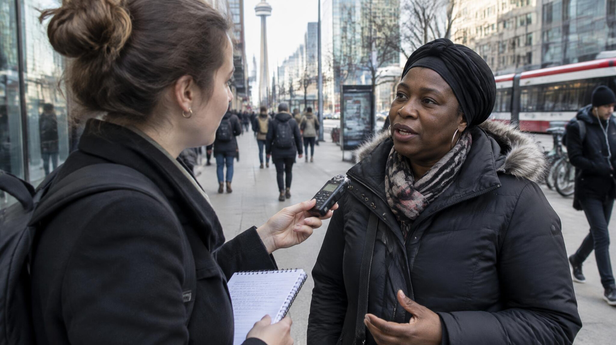 Journalist interviewing a person on a Toronto street